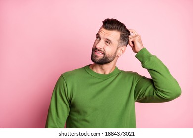 Photo portrait of unsure clueless man looking empty space wearing green jumper isolated pastel pink color background - Shutterstock ID 1884373021
