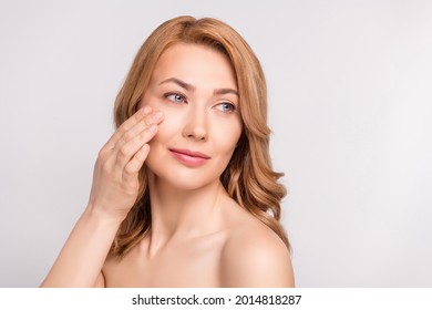 Photo portrait woman after shower naked shoulders applying anti age face cream looking empty space isolated white color background