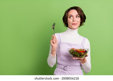 Photo portrait woman keeping salad hungry looking copyspace isolated pastel green color background