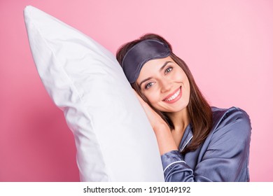 Photo portrait of woman laying on pillow isolated on pastel pink colored background