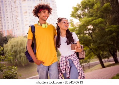 Photo portrait young couple walking after college laughing drinking coffee in green park - Powered by Shutterstock