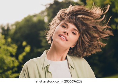 Photo portrait young girl with smiling throwing hair outdoors in summer sunny green park - Shutterstock ID 2056696232