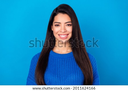 Photo portrait young girl smiling cheerful wearing blue casual sweater isolated on bright blue color background