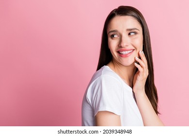 Photo portrait young woman tender touching cheek looking copyspace isolated pastel pink color background - Shutterstock ID 2039348948