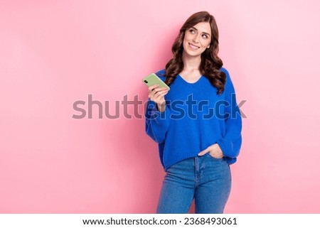 Photo of positive adorable girl wear blue stylish jumper look empty space autumn seasonal offer isolated on pink color background