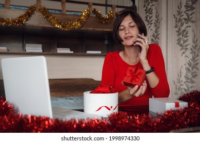 Photo Of Positive Asian Lady Sit In Bedroom And Call By Cellphone With Christmas X-mas Ornament. X-mas, Winter Holidays And People Concept In Covid Time