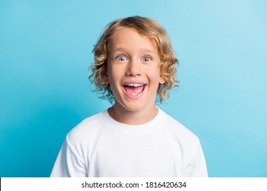 Photo of positive boy feel astonished open mouth wear white casual style outfit isolated over blue color background - Shutterstock ID 1816420634