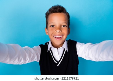 Photo Of Positive Charming Little Guy Dressed Black Vest Smiling Recording Self Video Isolated Blue Color Background