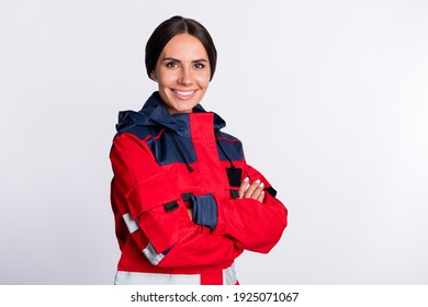 Photo of positive charming young lady paramedic dressed red uniform smiling hands folded isolated white color background