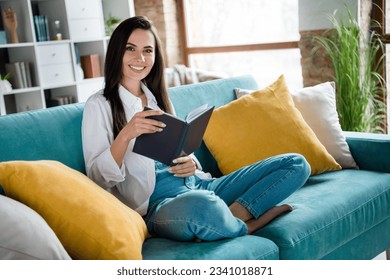 Photo of positive cheerful lady sitting comfy divan reading interesting boon in sunlit flat house - Powered by Shutterstock