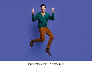 Photo of positive cheerful nice man wear stylish clothes demonstrate v-sign have fun good mood isolated on violet color background