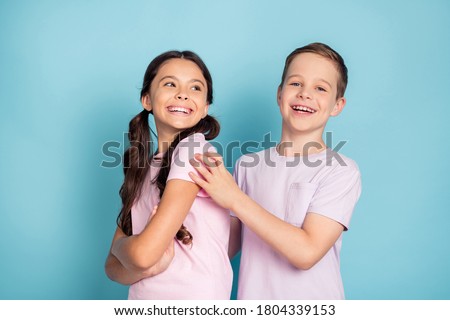 Photo of positive cheerful two kids boy girl happy family concept wear good look clothes isolated over blue color background