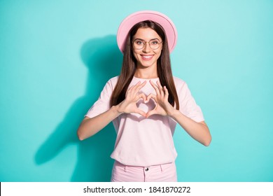 Photo of positive cheerful young lady make fingers heart show love symbol isolated over teal color background - Powered by Shutterstock