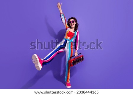 Photo of positive cool girl dancing active energetic with boom box pop music isolated on vivid color background