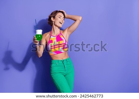 Photo of positive cute girl wear trendy clothes drink mojito alcohol enjoy summer party empty space isolated on purple color background
