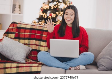 Photo of positive friendly lady dressed knitted x-mas sweater communicating modern gadget indoors house room - Powered by Shutterstock