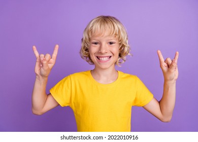 Photo Of Positive Funky Blonde Kid Rocker Fan Boy Toothy Smile Wear Yellow T-shirt Isolated Violet Color Background