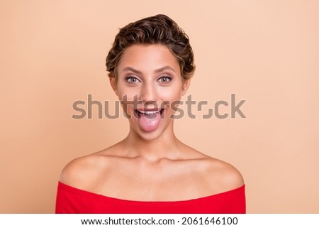 Photo of positive funky cheerful lady stick out tongue make silly face reaction isolated on pastel beige color background