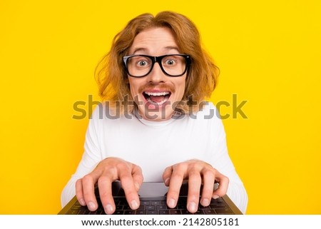Photo of positive funky guy wear white shirt spectacles chatting modern gadget isolated yellow color background