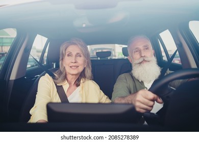 Photo of positive good mood retired couple wear casual clothes driving automobile smiling outside urban city street