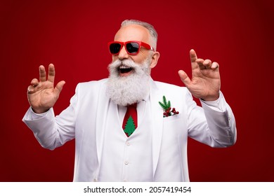 Photo Of Positive Happy Grey Haired Cheerful Man Look Empty Space Dance Clubber Christmas Isolated On Red Color Background