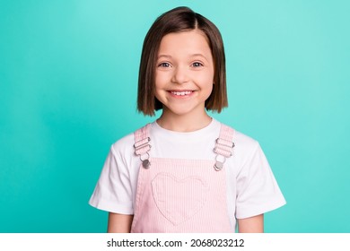 Photo of positive happy little small girl smile beaming good mood isolated on pastel teal color background