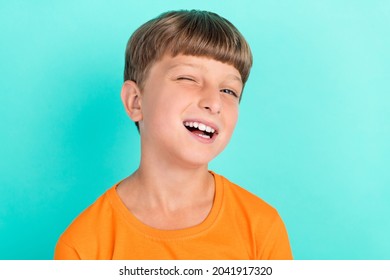 Photo Of Positive Happy Young Little Boy Wink Eye Good Mood Enjoy Smile Isolated On Teal Color Background