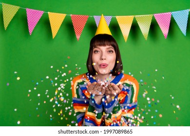 Photo Of Positive Happy Young Nice Woman Blow Hands Confetti Birthday Party Isolated On Green Color Background