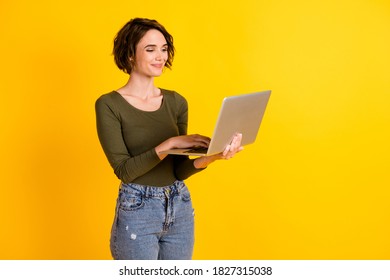 Photo Of Positive Lady Chatting On Laptop Wear Green Sweater Isolated Over Bright Yellow Color Background