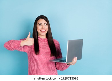 Photo of positive lady hold laptop show thumb up look interested empty space isolated on blue color background