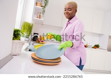 Photo of positive lady wash doing dishes hold sponge have good mood house indoors