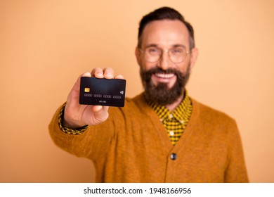 Photo Of Positive Mature Man Show Credit Card In Camera Isolated Over Beige Color Background