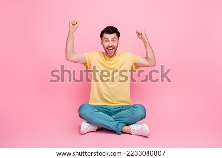 Photo of positive nice man raise muscular arms support football team say yeah goal isolated on pink color background