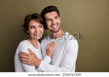 Photo of positive people toothy smile wear white trendy clothes interested looking empty space offer isolated on brown color background