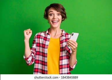 Photo Of Positive Person Fist Up Success Subscribe Hold Gadget Plaid Outfit Isolated On Green Color Background