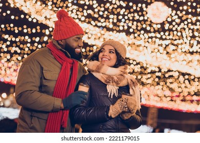 Photo of positive pretty boyfriend girlfriend dressed winter season outfits drinking x-mas beverages outdoors urban city street
