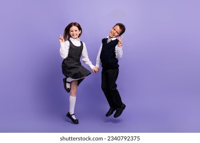 Photo of positive schoolkids jump make v sign in classroom lesson isolated bright color background
