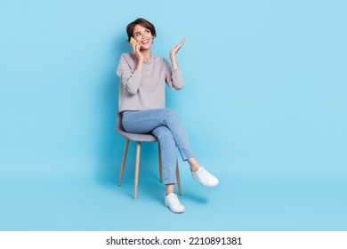 Photo of positive stylish lady office manager speak telephone modern device interested look empty space isolated on blue color background - Powered by Shutterstock