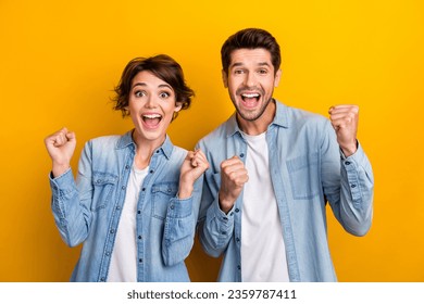 Photo of positive surprised couple lady guy impressed winning lottery raise fists up isolated shine color background - Shutterstock ID 2359787411
