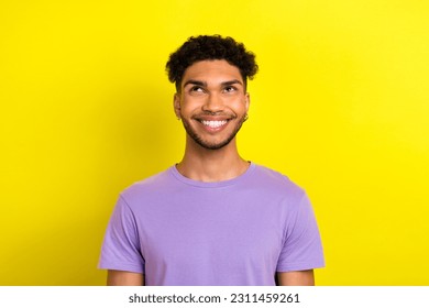 Photo of positive thoughtful guy dressed purple t-shirt looking up empty space isolated yellow color background - Shutterstock ID 2311459261