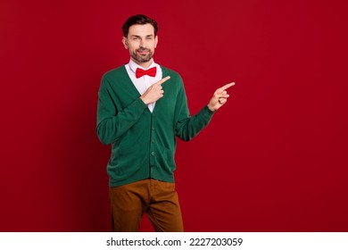 Photo postcard of young satisfied man wear green cardigan red bowtie fingers direct mockup shopping winter offer isolated on red color background