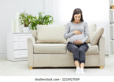 Photo of pregnant woman touching her stomach. - Powered by Shutterstock