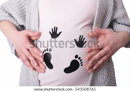 Photo of pregnant woman touching her belly with hands