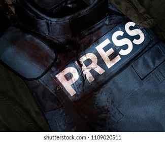 Photo Of A Press Journalist Armor War Protective Vest In Blood Splatter Depicting Mass Media War Victims.