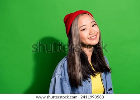 Photo of pretty adorable girl dressed jeans shirt smiling white teeth empty space isolated green color background