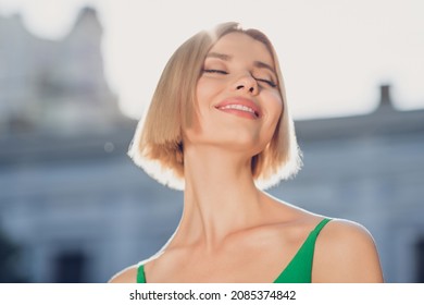 Photo Of Pretty Adorable Young Lady Wear Green Outfit Smiling Enjoying Sunshine Closed Eyes Outside Urban City Street