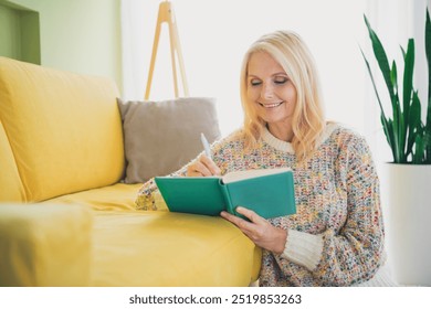 Photo of pretty aged woman pen write notepad wear pullover living room apartment indoors - Powered by Shutterstock