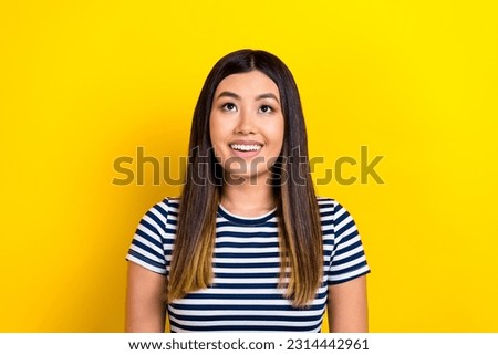 Photo of pretty asian ethnicity lady ombre dyed hairstyle look up empty space sale shopping offer isolated yellow background