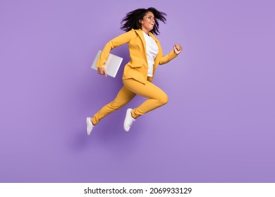 Photo of pretty charming woman dressed suit spectacles holding device jumping running isolated violet color background
