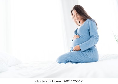 Photo of pretty charming young mom nightwear sitting bed talking baby belly indoors house room - Powered by Shutterstock